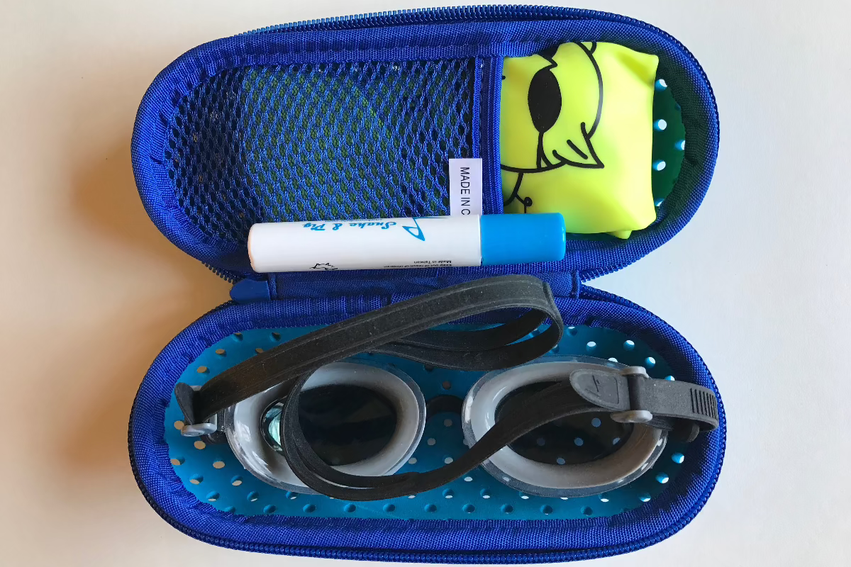 Case shown with goggles, cap and antifog tube inside illustrating how it can be used