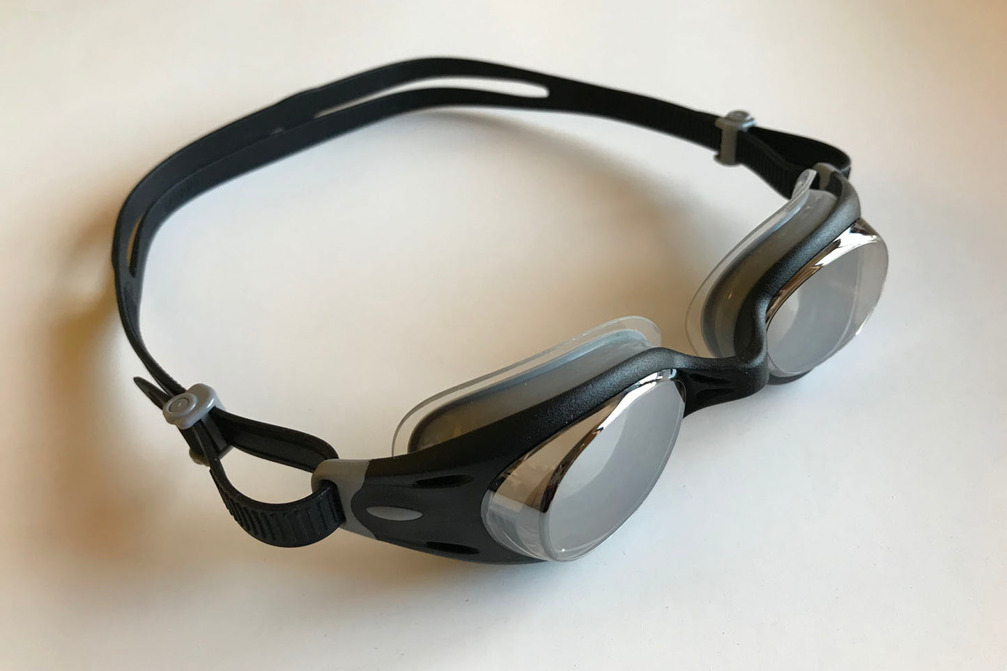 A side view of the black clear Junior Basilisk goggles from Snake & Pig