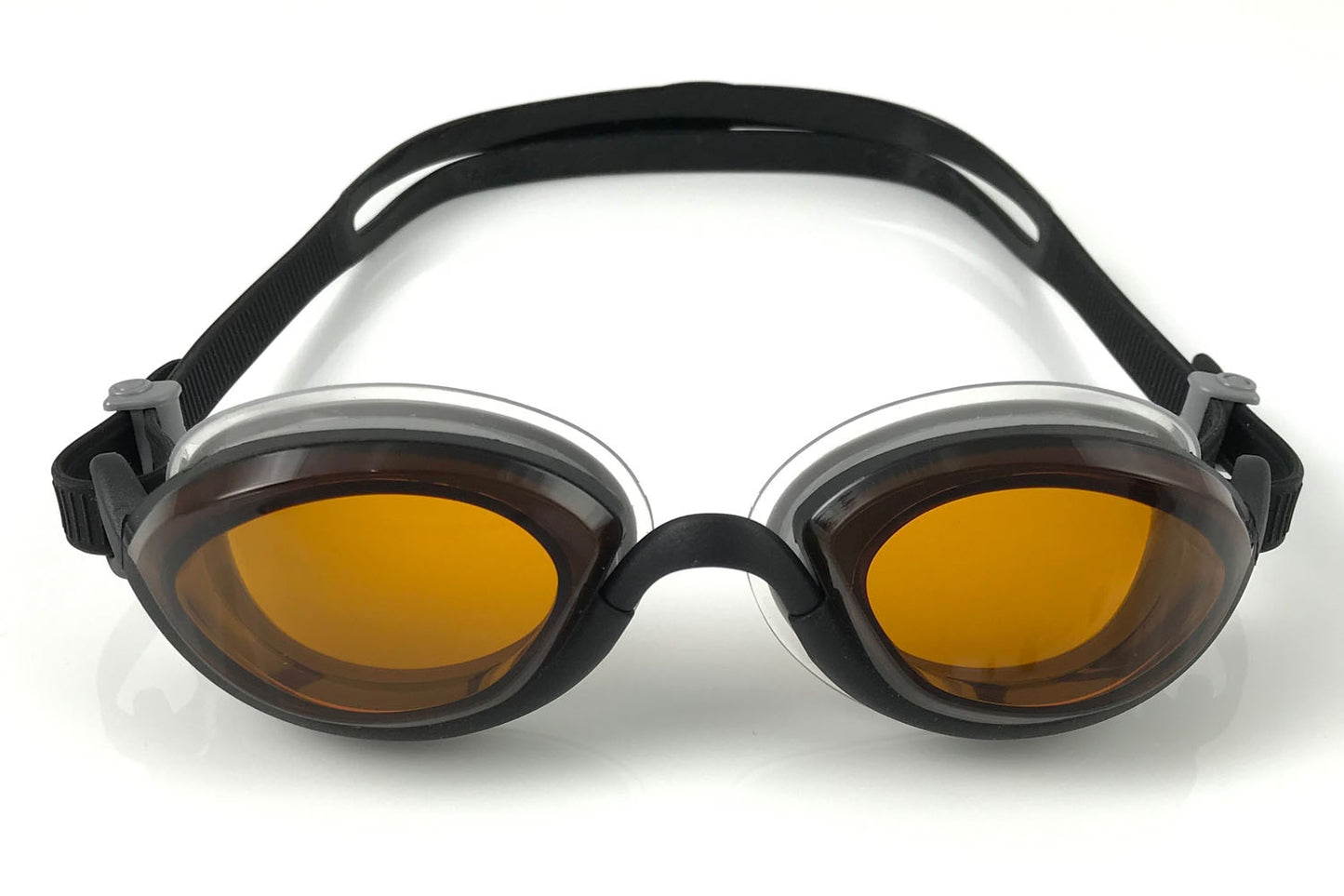 Snake & Pig goggles with amber lenses and black frames + straps shown from the front on a white background