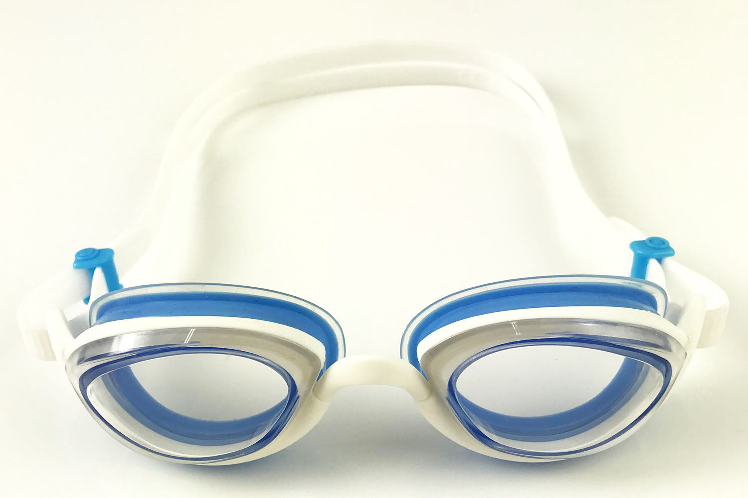 A pair of clear Snake & Pig goggles featuring completely clear lenses, white frames and strap, and light blue gaskets and fish-tail rolling buckles.