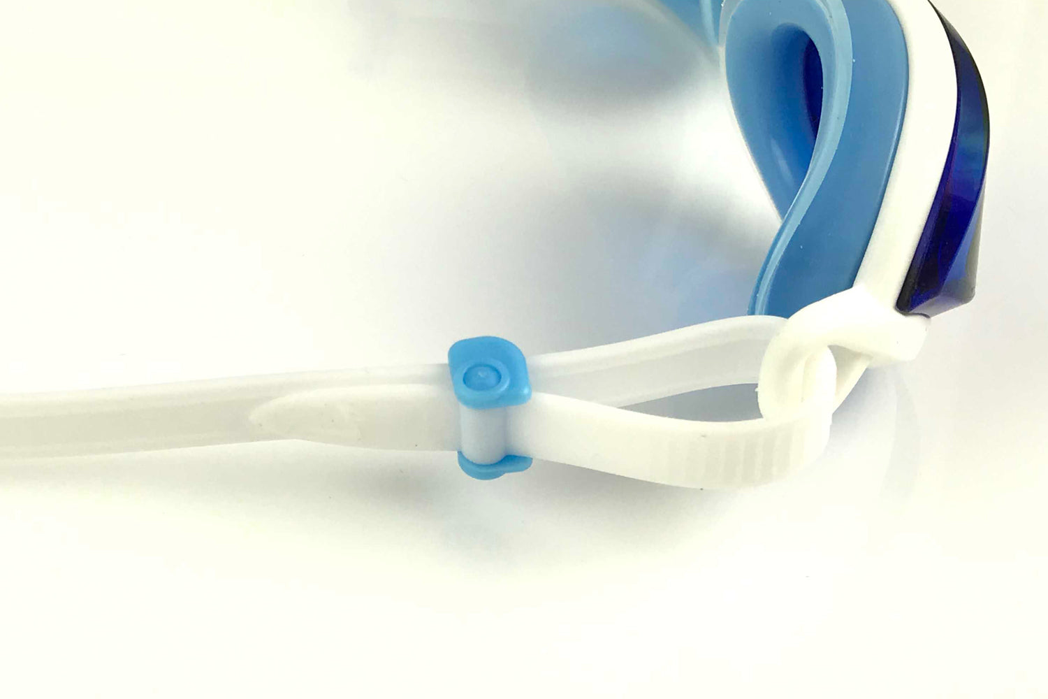 Close-up of the blue fishtail rolling buckle on the white strap of a pair of blue tinted goggles