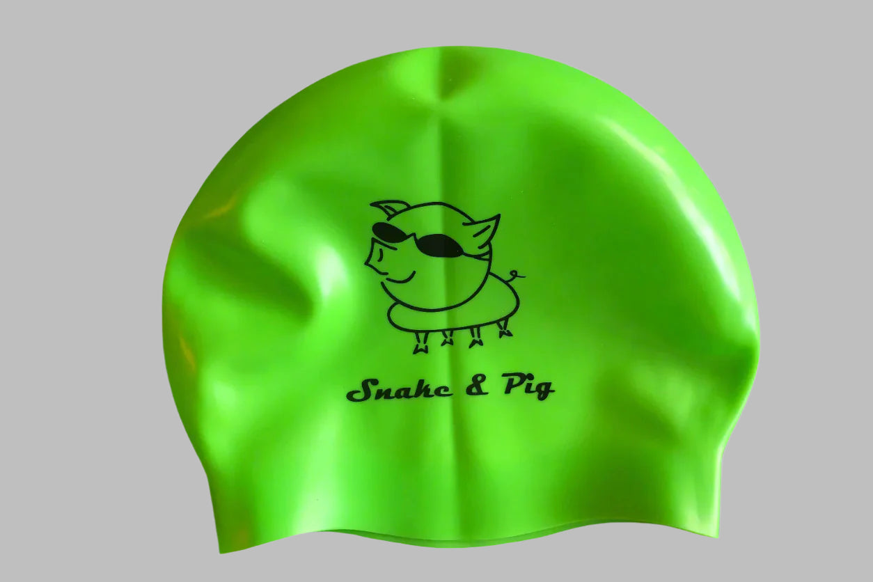 Neon green silicone cap for open water swimming. Black printed logo for Snake & Pig.