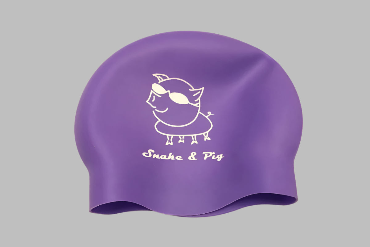 Snake & Pig logo printed in white on a lavender silicone swim cap