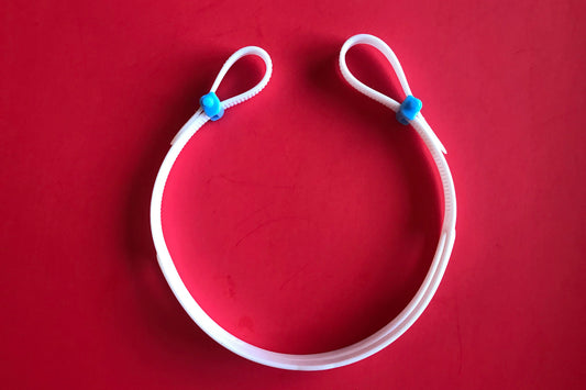 A white replacement strap with two blue buckles on a red background - for Snake & Pig goggles