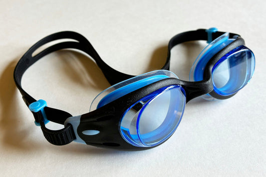 Side view of junior goggles with light blue lenses and black frames