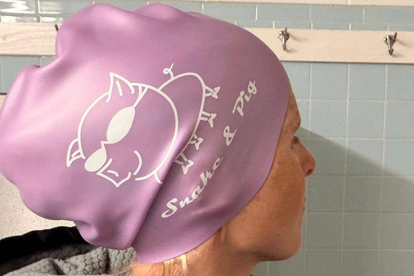 Woman with waist-length hair wearing small braid cap showing the large size of the opening and volume of the cap.