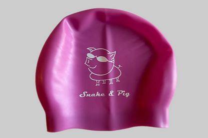 Light purple swim cap with white Snake & Pig logo on a light grey background