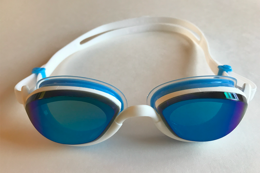 Blue tinted Snake & Pig goggles with white frames and blue air cushion gaskets