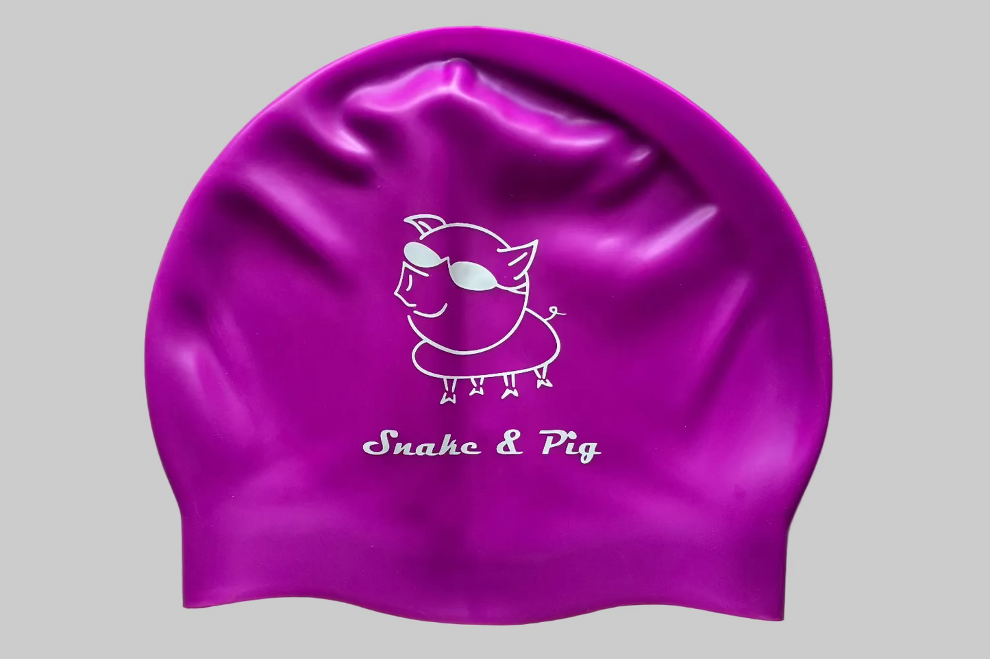 Purple silicone Snake & Pig logo swim cap on a white background